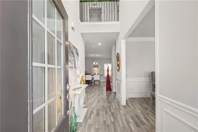 a view of a hallway with wooden floor and staircase