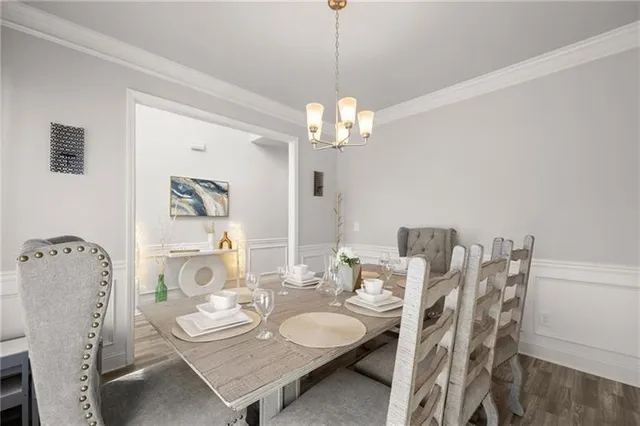 a dining room with furniture a chandelier and wooden floor