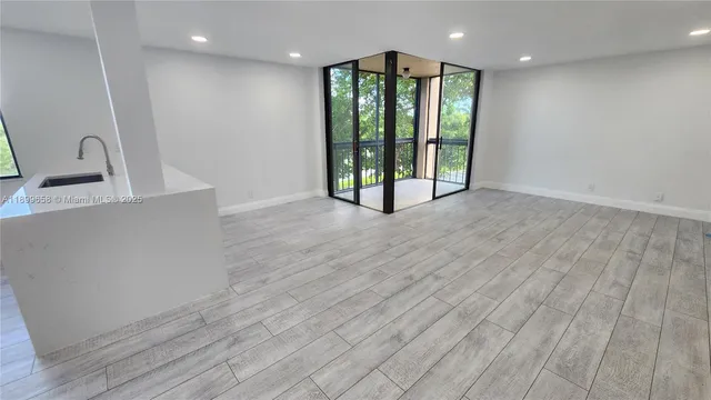 a view of an empty room with glass door
