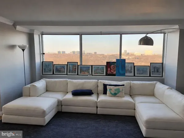 a living room with furniture and a large window