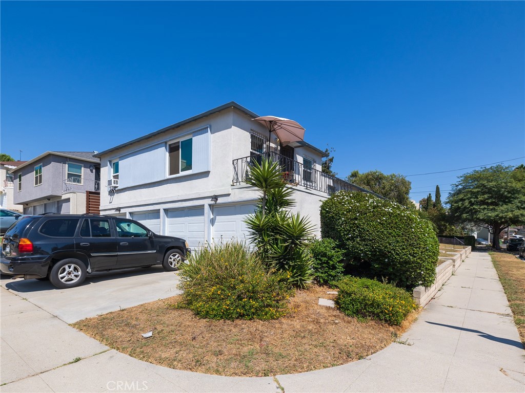 7019 Ramsgate Avenue Los Angeles, CA 90045 - Photo 15 of 19 a front view of a house with a garden