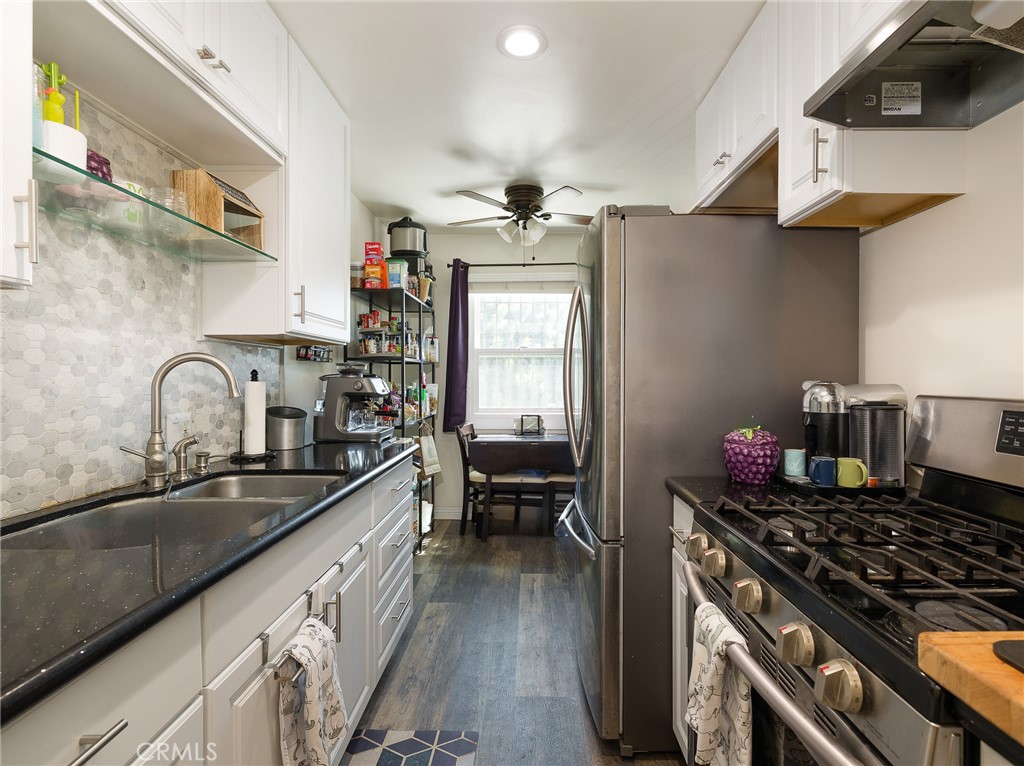 7019 Ramsgate Avenue Los Angeles, CA 90045 - Photo 10 of 19 a kitchen with stainless steel appliances granite countertop a sink stove and refrigerator