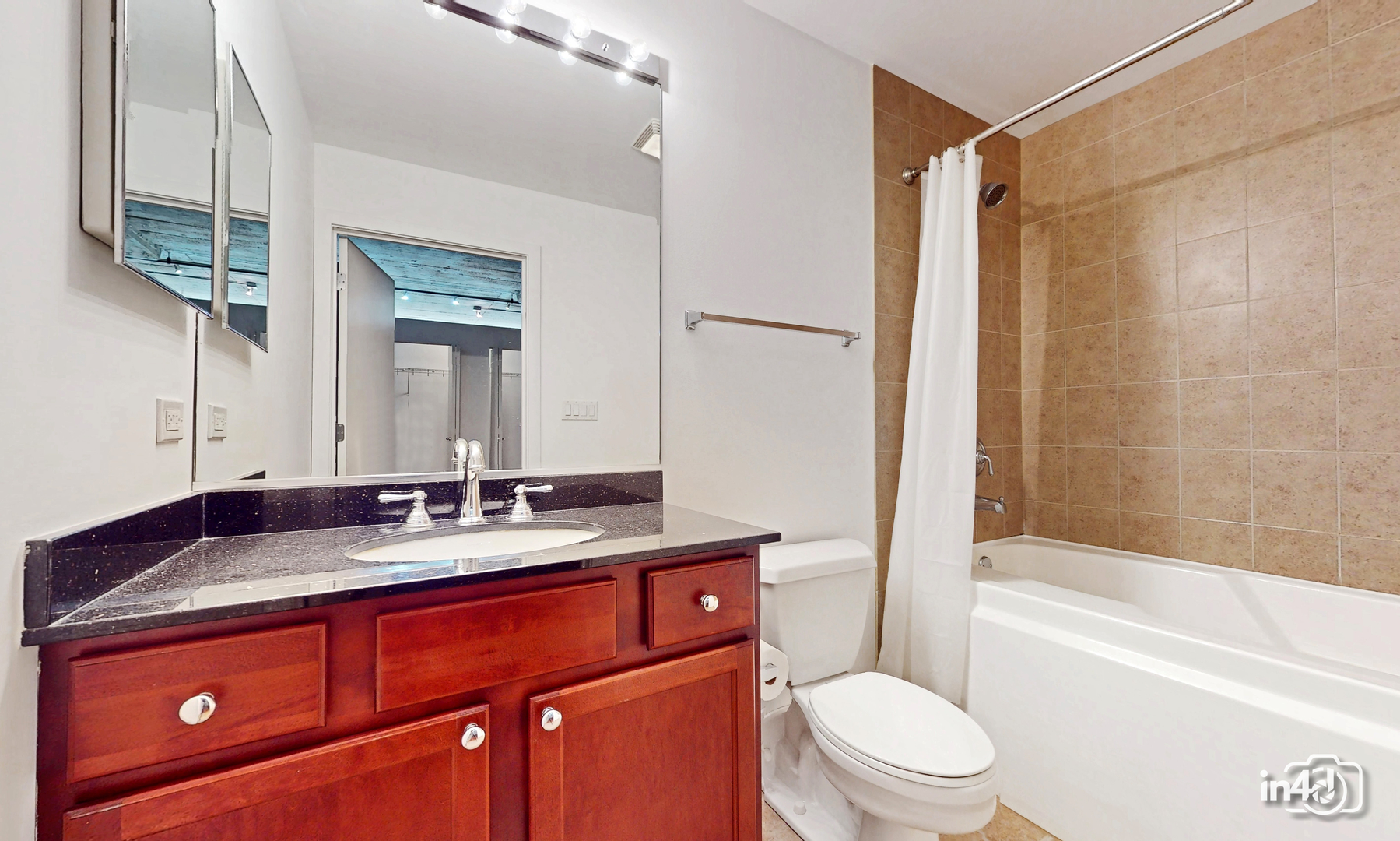 1150 West 15th Street, Unit 232 Chicago, IL 60608 - Photo 16 of 33 a bathroom with a granite countertop sink toilet mirror and bathtub