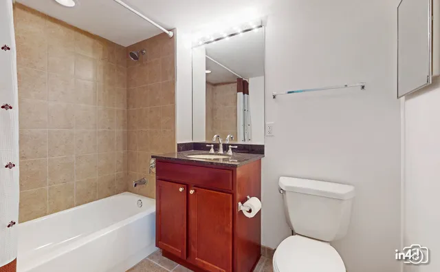 a bathroom with a toilet a sink and bathtub
