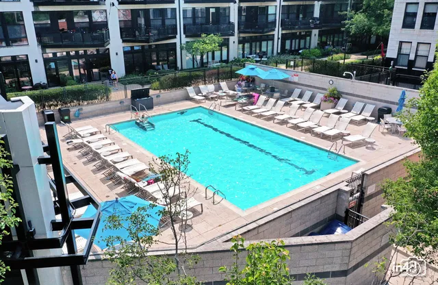 a view of a chairs and table in the patio with a swimming pool