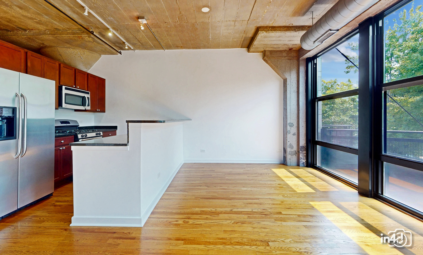 1150 West 15th Street, Unit 232 Chicago, IL 60608 - Photo 4 of 33 a bedroom with a bed and wooden floor