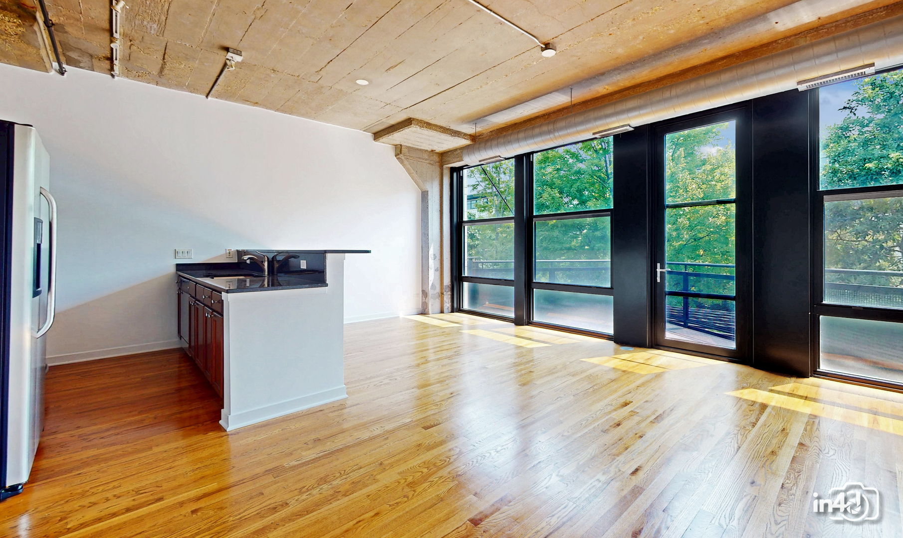 1150 West 15th Street, Unit 232 Chicago, IL 60608 - Photo 8 of 33 a view of empty room with wooden floor and fan