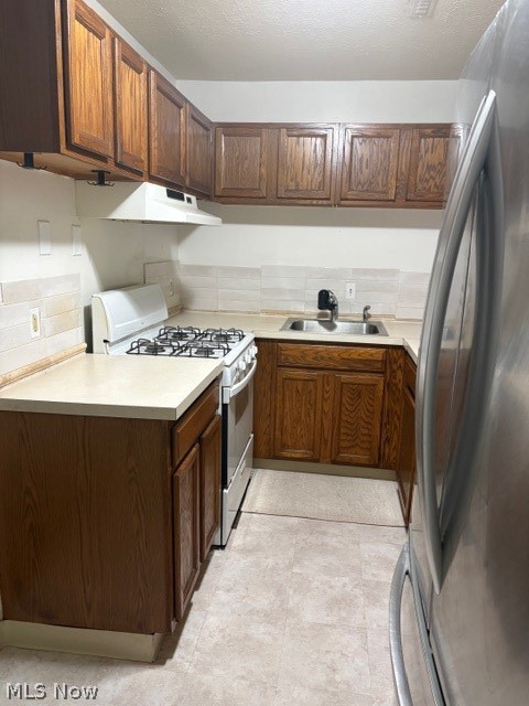 25735 Lorain Road, Unit 120 North Olmsted, OH 44070 - Photo 4 of 11 Kitchen featuring range, light countertops, fridge, backsplash, and exhaust hood