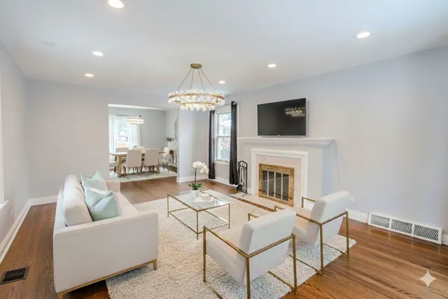 a living room with furniture a fireplace and a flat screen tv