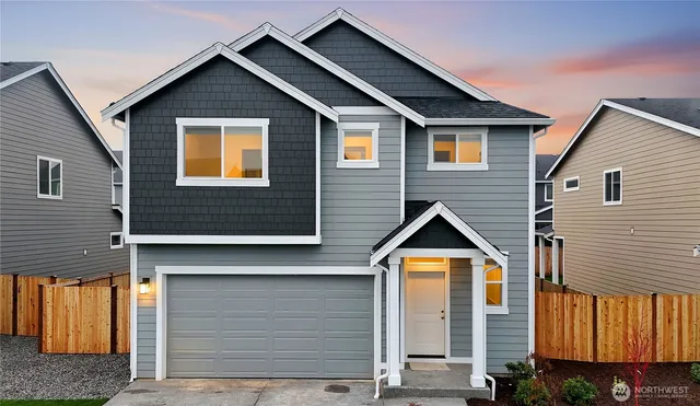 a view of a house with wooden fence