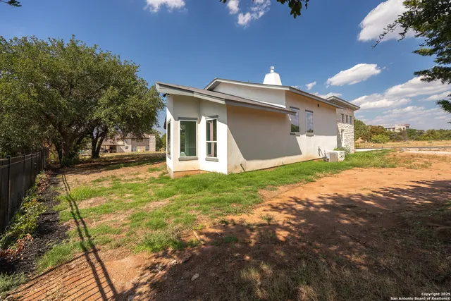a view of a house with backyard and porch