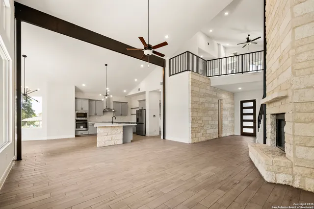 a view of a kitchen with a sink and a refrigerator