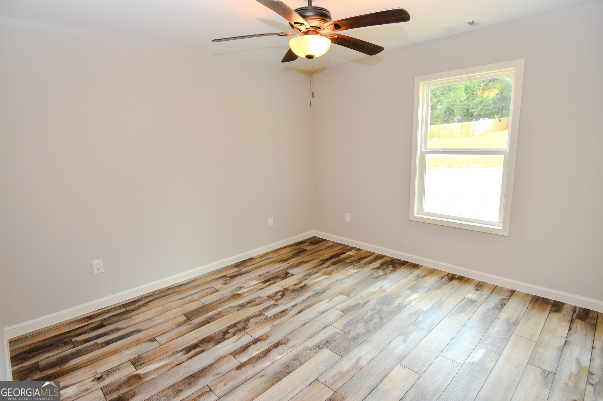 101 Alexandria Way Thomaston, GA 30286 - Photo 13 of 39 wooden floor in an empty room with a window