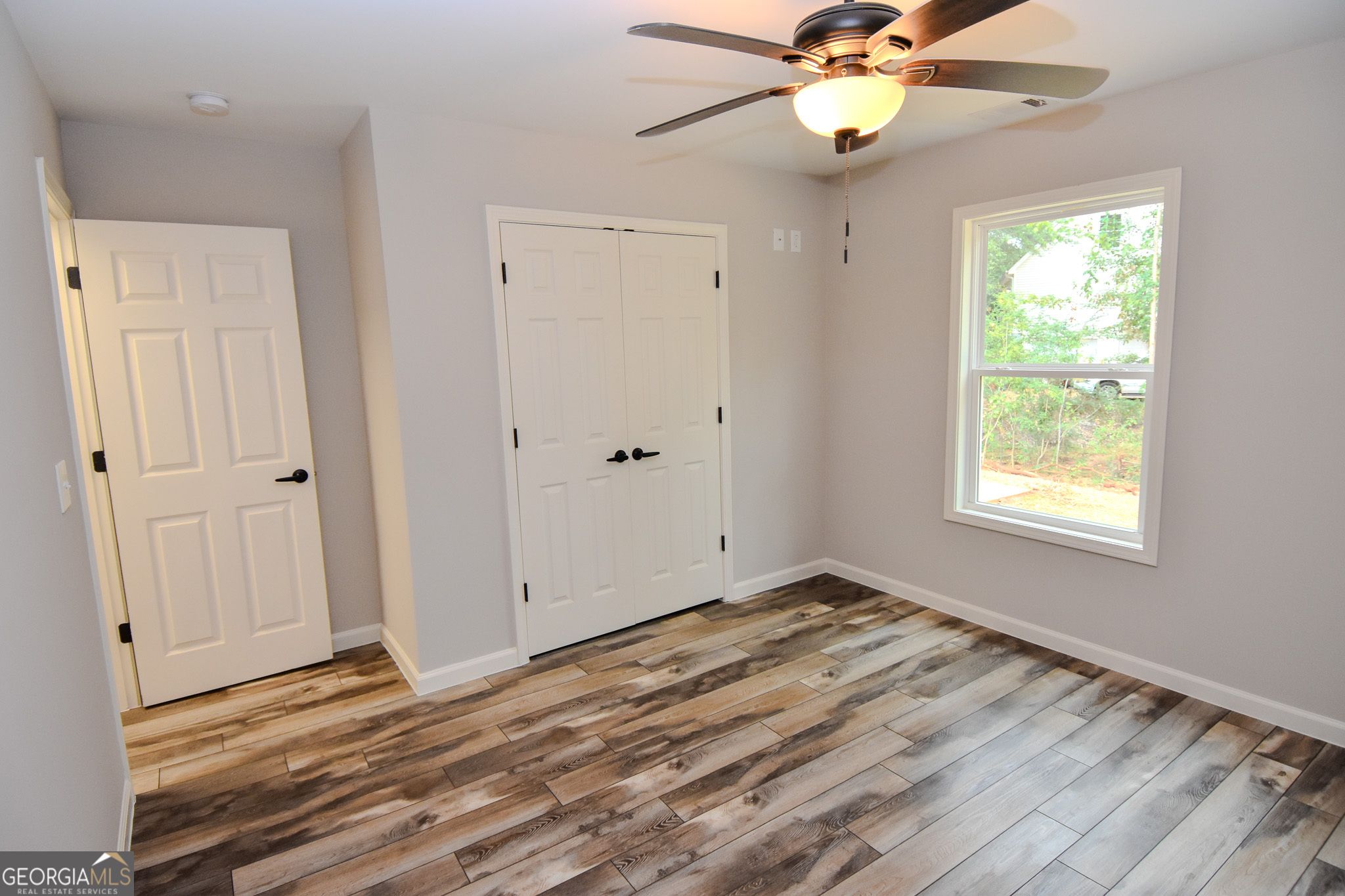 101 Alexandria Way Thomaston, GA 30286 - Photo 18 of 39 wooden floor in an empty room with a window