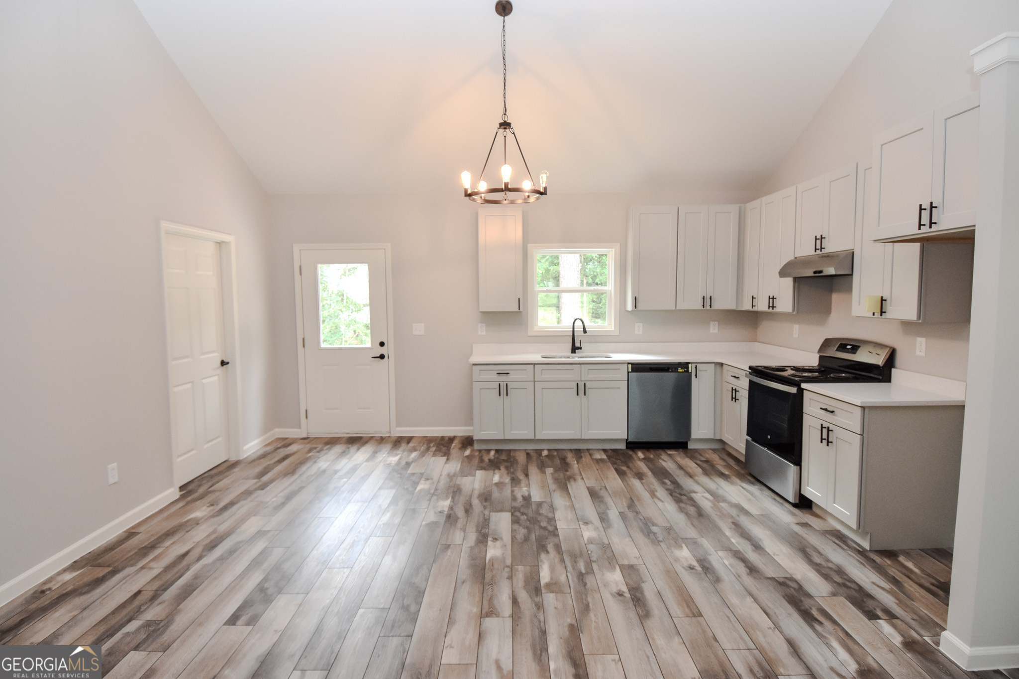 101 Alexandria Way Thomaston, GA 30286 - Photo 28 of 39 a kitchen with granite countertop white cabinets stainless steel appliances and window