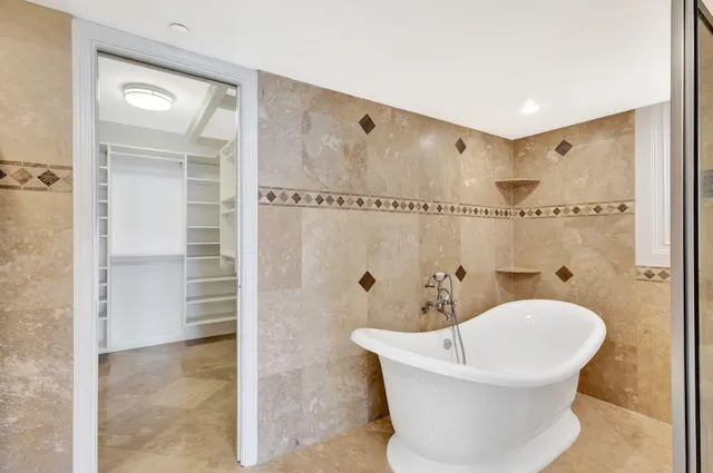 a living room with furniture a chandelier and a flat screen tv
