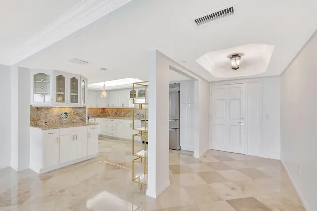 a kitchen with cabinets and wooden floor