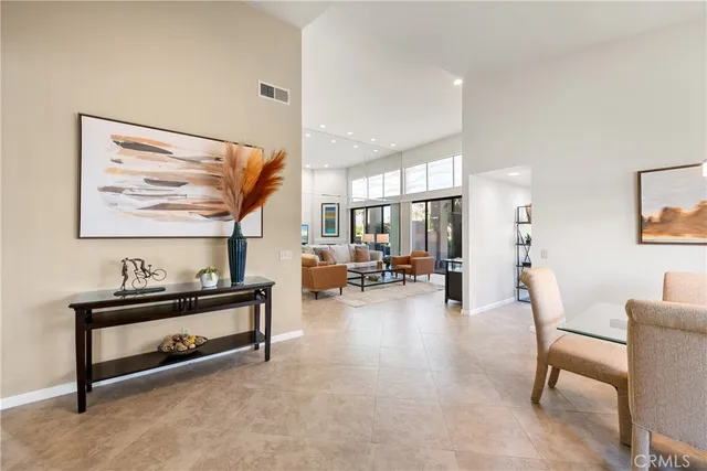 a living room with furniture and a painting on the wall