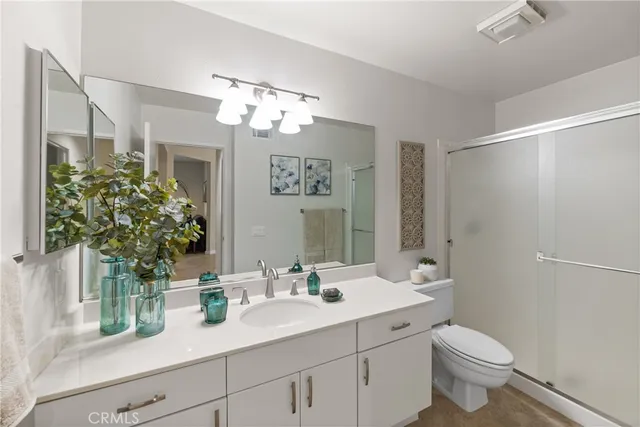 a bathroom with a sink a toilet and mirror