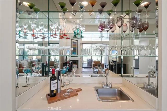a kitchen area with a sink and view of living room