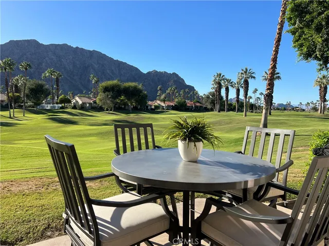 a view of a dining table and chairs on the terrace