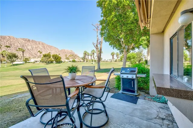 a view of a chairs and table in patio