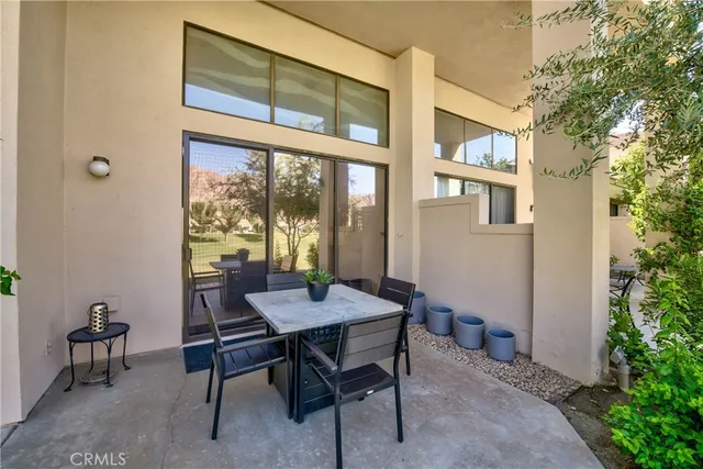 a view of a house that has a table and chairs in it