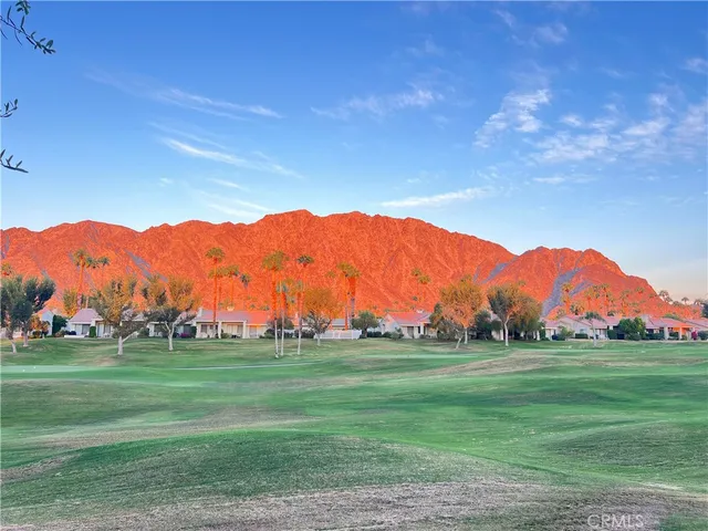 a view of grassy field with mountain