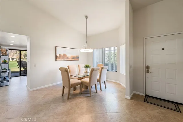 a dining room with furniture window and wooden floor