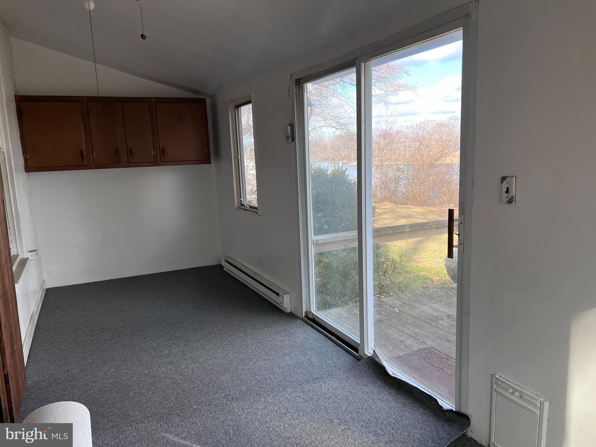 1 Punte Lane Essex, MD 21221 - Photo 33 of 37 a view of an empty room with a fireplace and a window