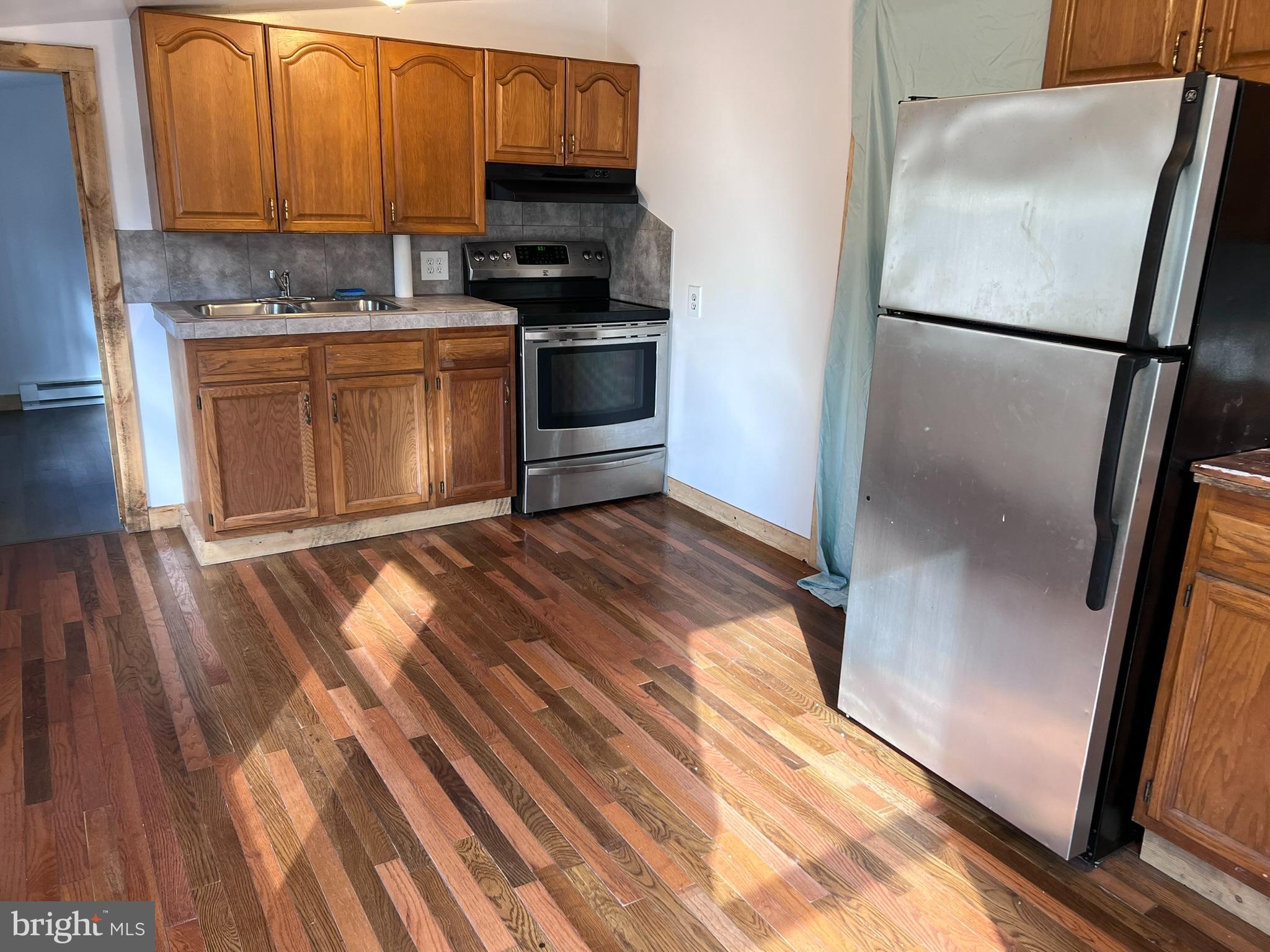 1 Punte Lane Essex, MD 21221 - Photo 5 of 37 a kitchen with a refrigerator and a sink