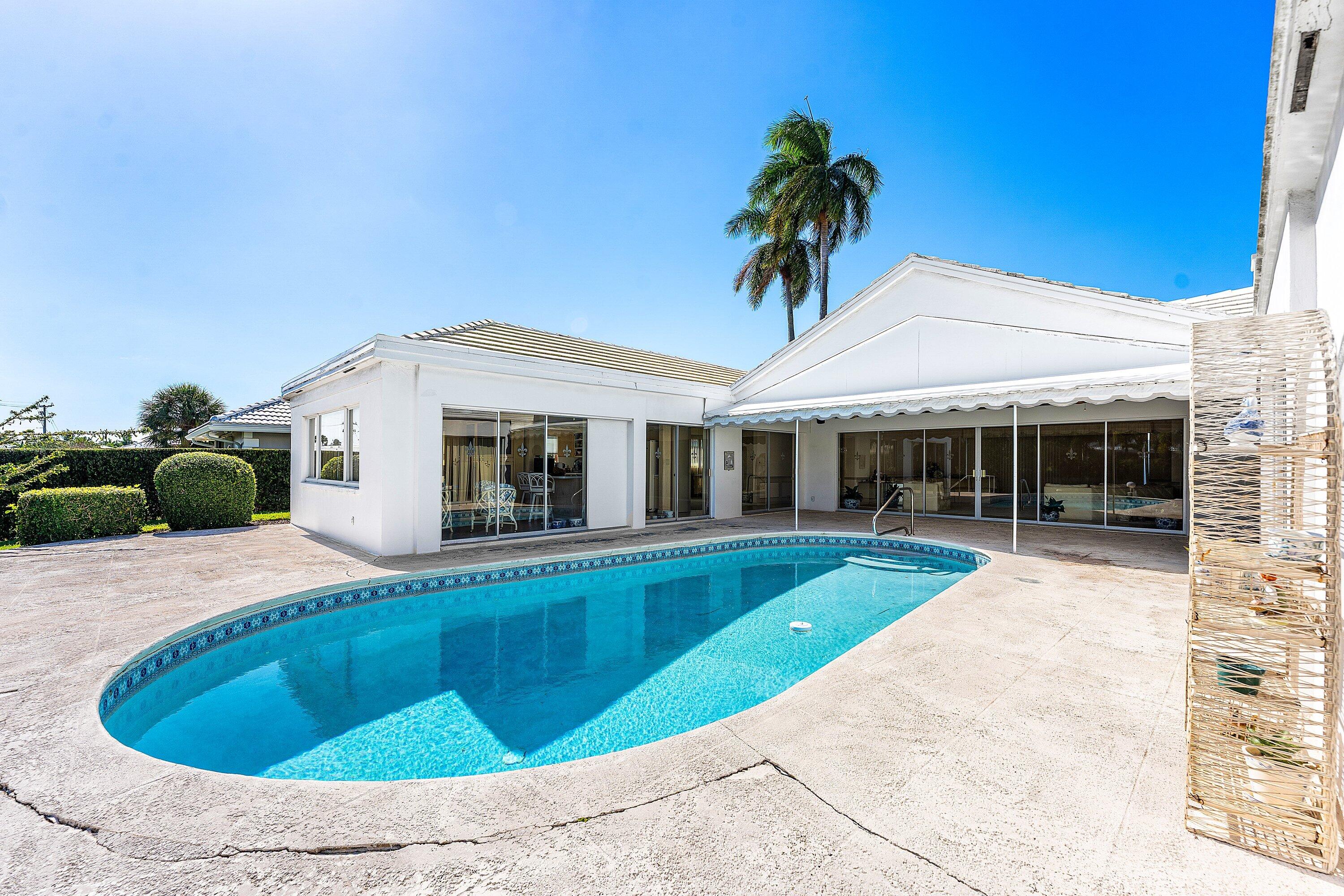 950 Mulberry Way Boca Raton, FL 33486 - Photo 9 of 23 a house with palm tree in front of it