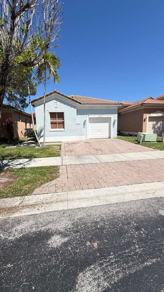2120 Northeast 37th Road, Unit 1 Homestead, FL 33033 - Photo 9 of 30 a house that has a tree in front of the house