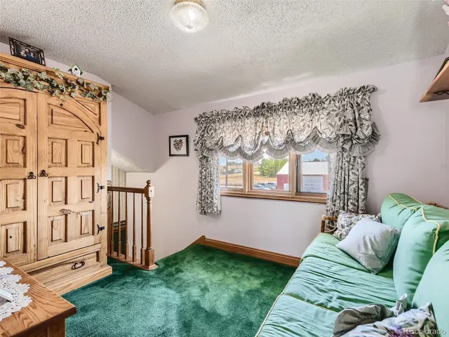 a view of an entryway with garden and patio