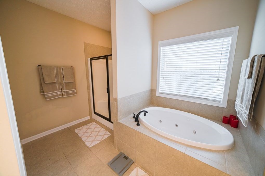 9570 Yarbrough Road Midland, GA 31820 - Photo 16 of 30 a bathroom with a bathtub and a window