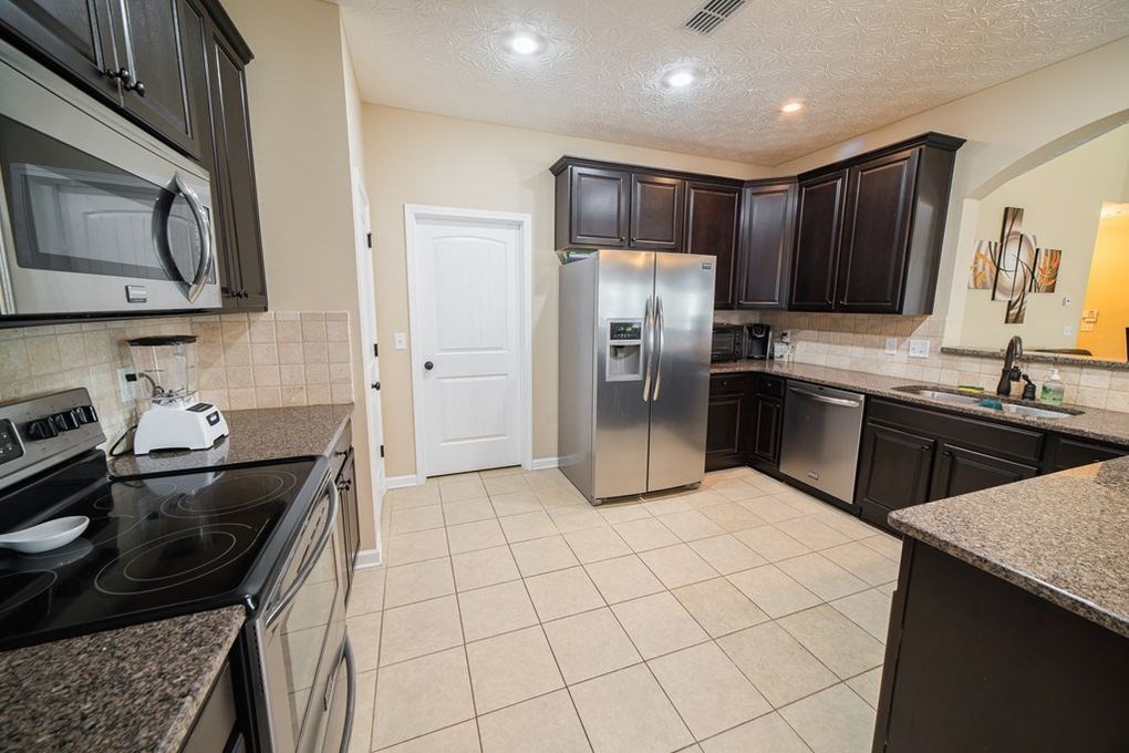 9570 Yarbrough Road Midland, GA 31820 - Photo 8 of 30 a kitchen with stainless steel appliances a sink stove refrigerator and cabinets