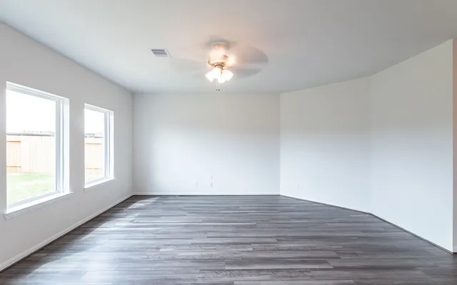 wooden floor in an empty room with a window