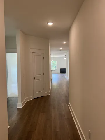 a view of a hallway with wooden floor