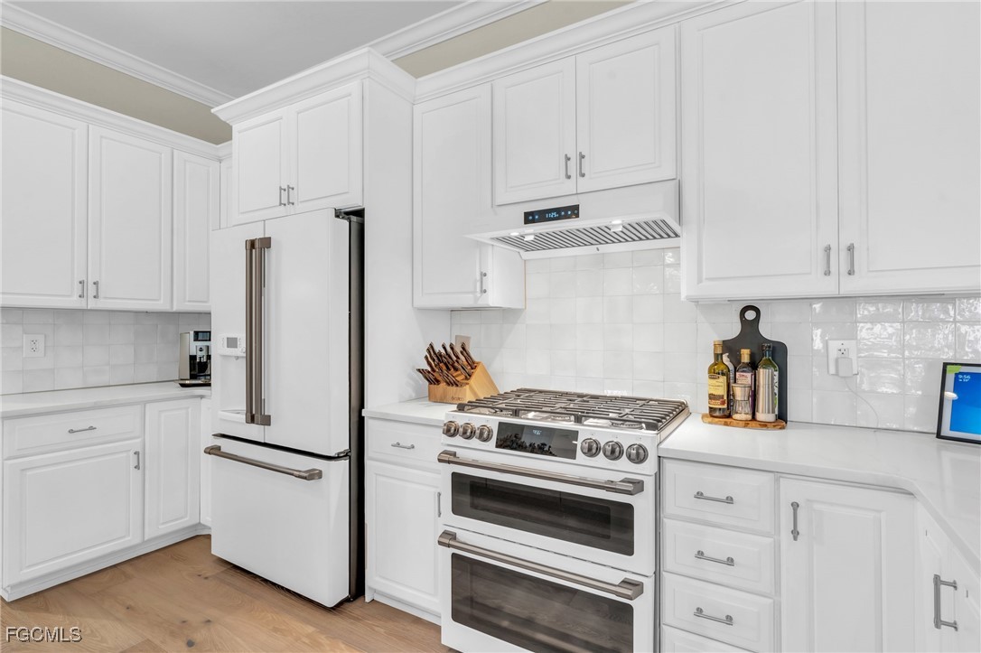 11451 Compass Point Drive Fort Myers, FL 33908 - Photo 14 of 47 a kitchen with cabinets appliances and a counter space
