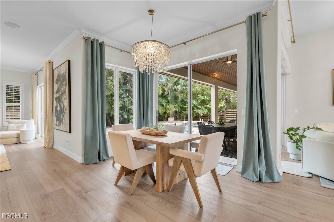 11451 Compass Point Drive Fort Myers, FL 33908 - Photo 17 of 47 a view of a dining room with furniture wooden floor and chandelier