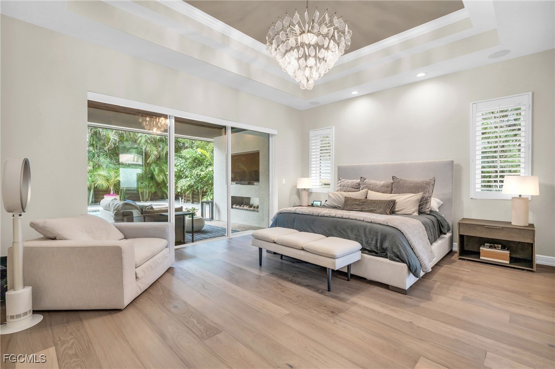 11451 Compass Point Drive Fort Myers, FL 33908 - Photo 20 of 47 a spacious bedroom with a bed and a large window