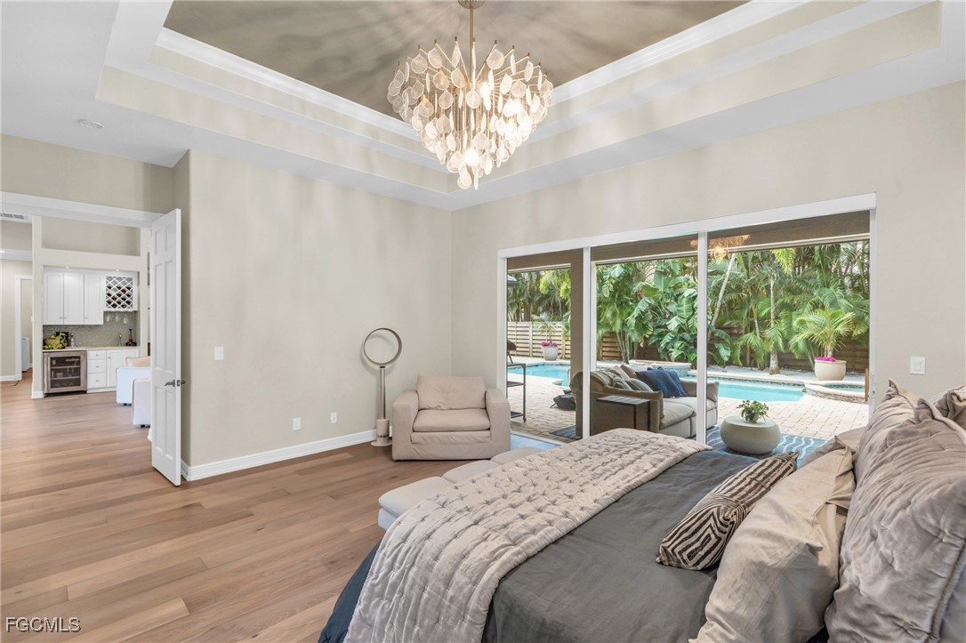 11451 Compass Point Drive Fort Myers, FL 33908 - Photo 22 of 47 a bedroom with a large bed and a large window
