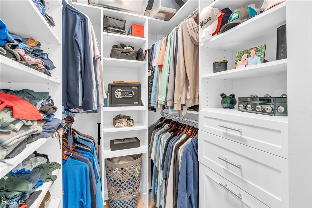 11451 Compass Point Drive Fort Myers, FL 33908 - Photo 26 of 47 a view of walk in closet with clothes and shoes
