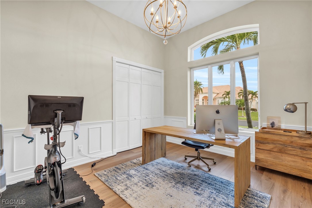 11451 Compass Point Drive Fort Myers, FL 33908 - Photo 28 of 47 a living room with furniture a window and gym equipment