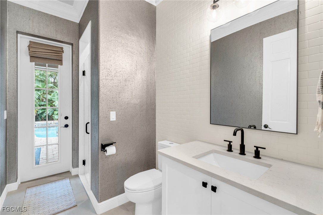 11451 Compass Point Drive Fort Myers, FL 33908 - Photo 30 of 47 a bathroom with a sink a toilet and shower