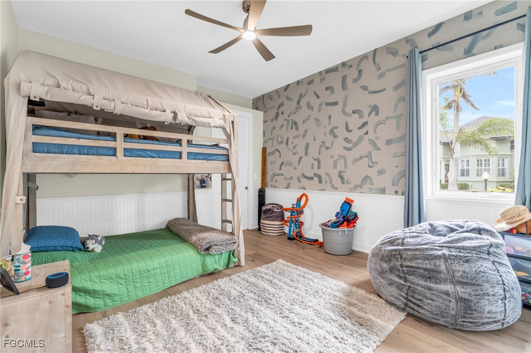 11451 Compass Point Drive Fort Myers, FL 33908 - Photo 33 of 47 a bedroom with a bed and a chandelier