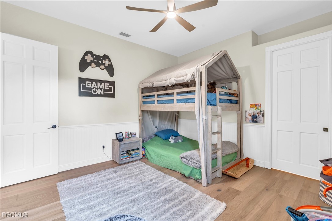 11451 Compass Point Drive Fort Myers, FL 33908 - Photo 34 of 47 a bedroom with bed and a wooden floor