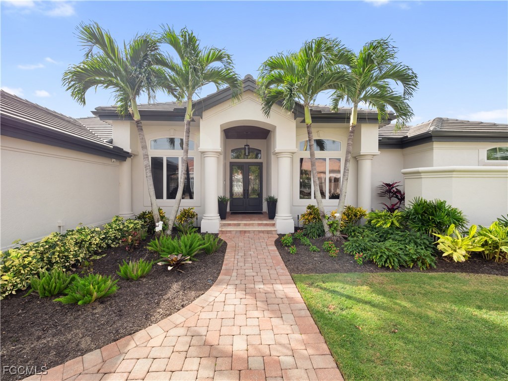 11451 Compass Point Drive Fort Myers, FL 33908 - Photo 47 of 47 a front view of a house with a garden