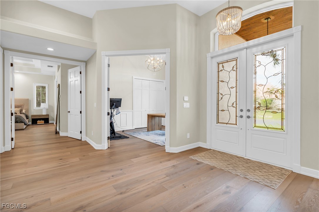 11451 Compass Point Drive Fort Myers, FL 33908 - Photo 7 of 47 wooden floor and windows in an empty room