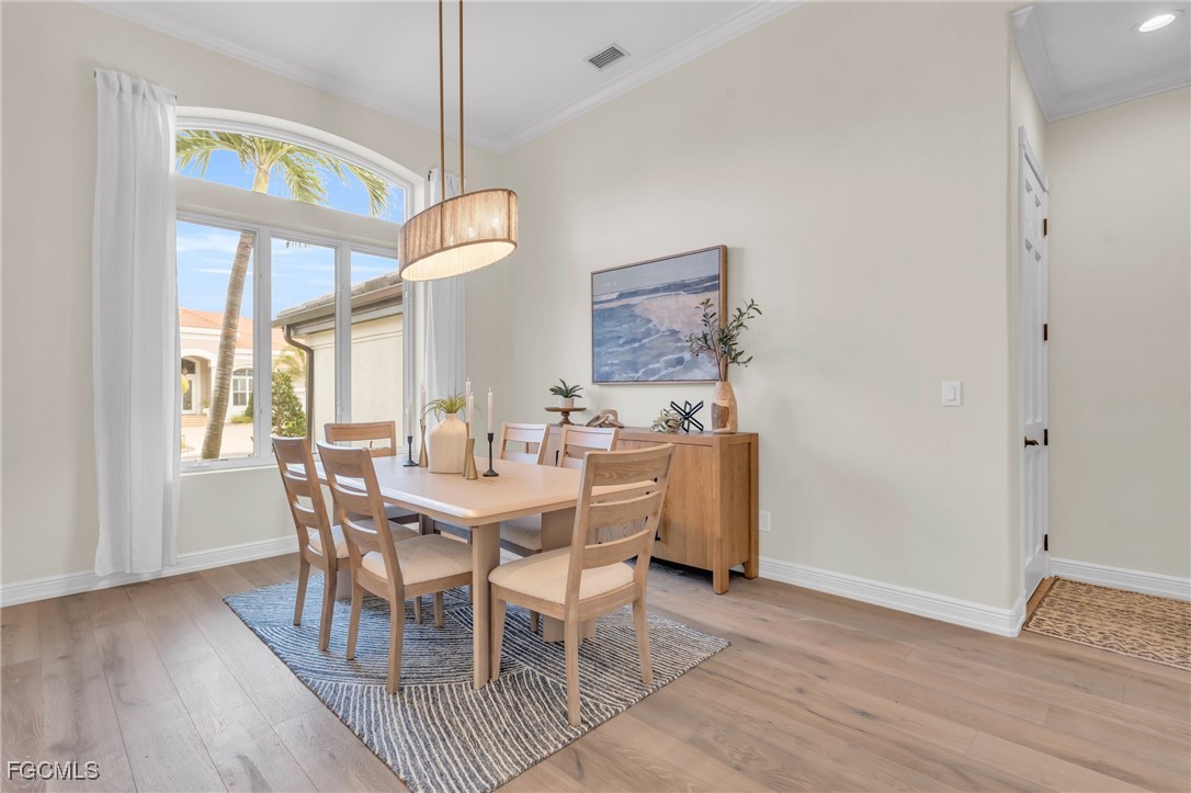 11451 Compass Point Drive Fort Myers, FL 33908 - Photo 9 of 47 a view of a dining room with furniture and wooden floor